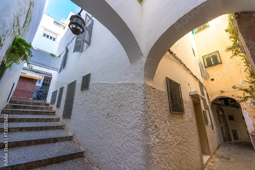 Beautiful corner in a narrow alley with arches and steps in the Medina of Tangier, Morocco