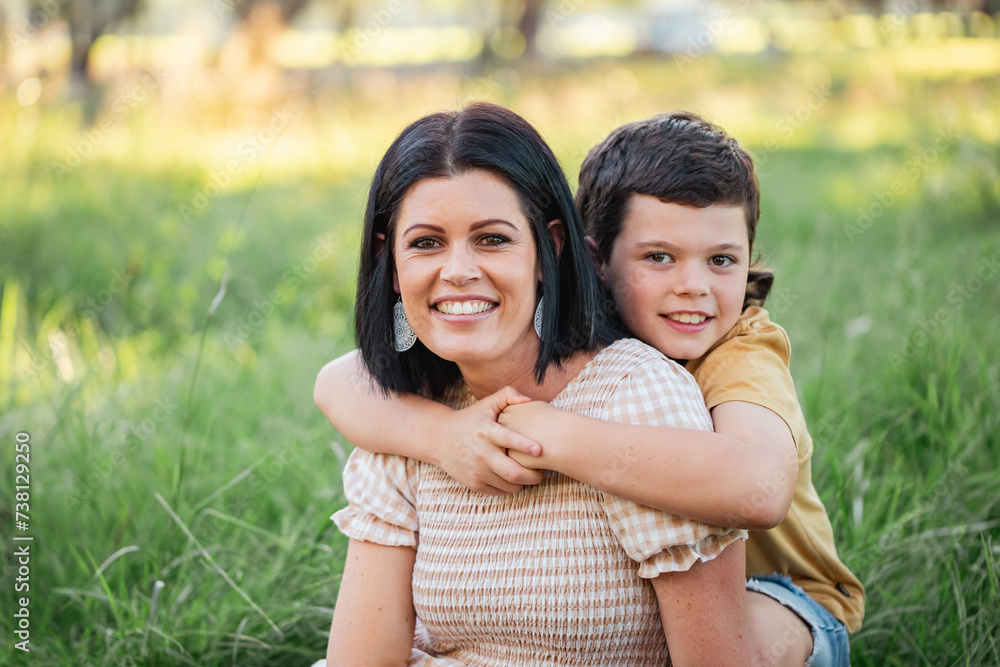 Portrait of mother and son sitting together in Australian bush setting Portrait of mother and son sitting together in Australian bush setting