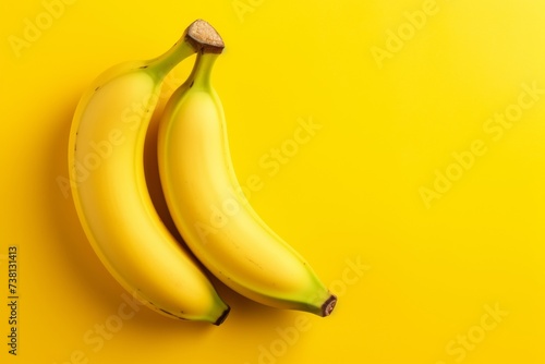 A bunch of fresh, ripe bananas on a matching yellow background.