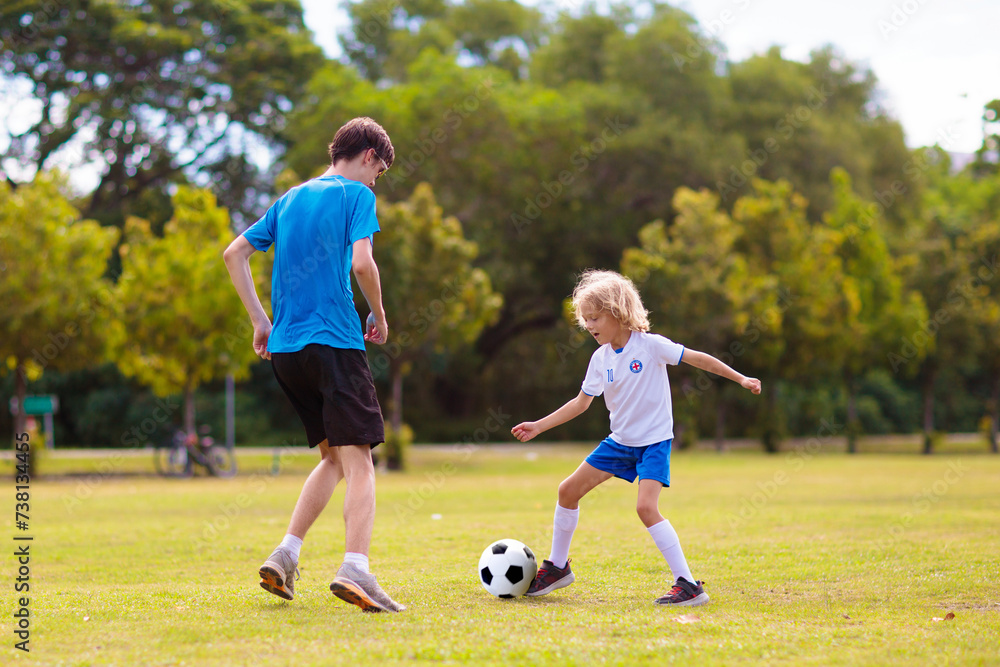 Kids play football. Child at soccer field. Kids play football. Child at soccer field.