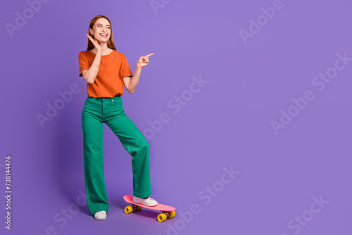 Photo of lovely adorable cute girl wear trendy clothes introduce proposition poster empty space isolated on purple color background