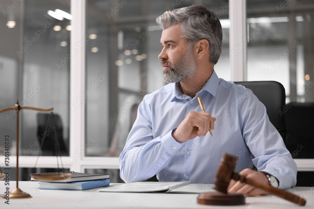 Serious lawyer at table in office, space for text Serious lawyer at table in office, space for text