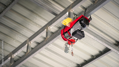 Fotografía Electric Hoist hangs on a steel frame ceiling in an industrial production workshop