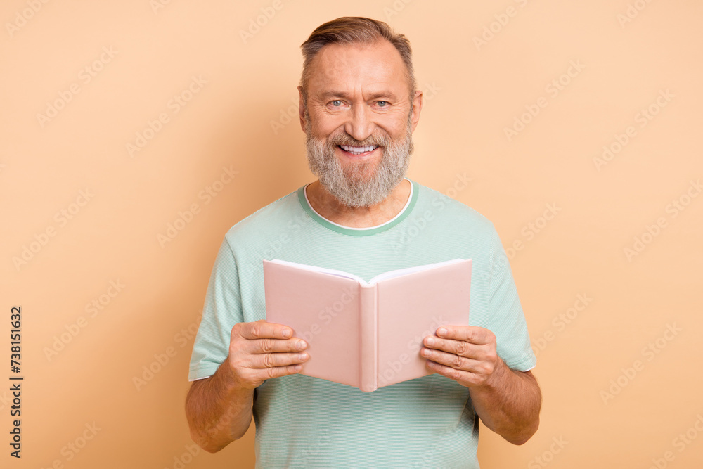 Photo of nice intelligent man wear stylish clothes reading interesting story hobby time isolated on beige color background Photo of nice intelligent man wear stylish clothes reading interesting story hobby time isolated on beige color background