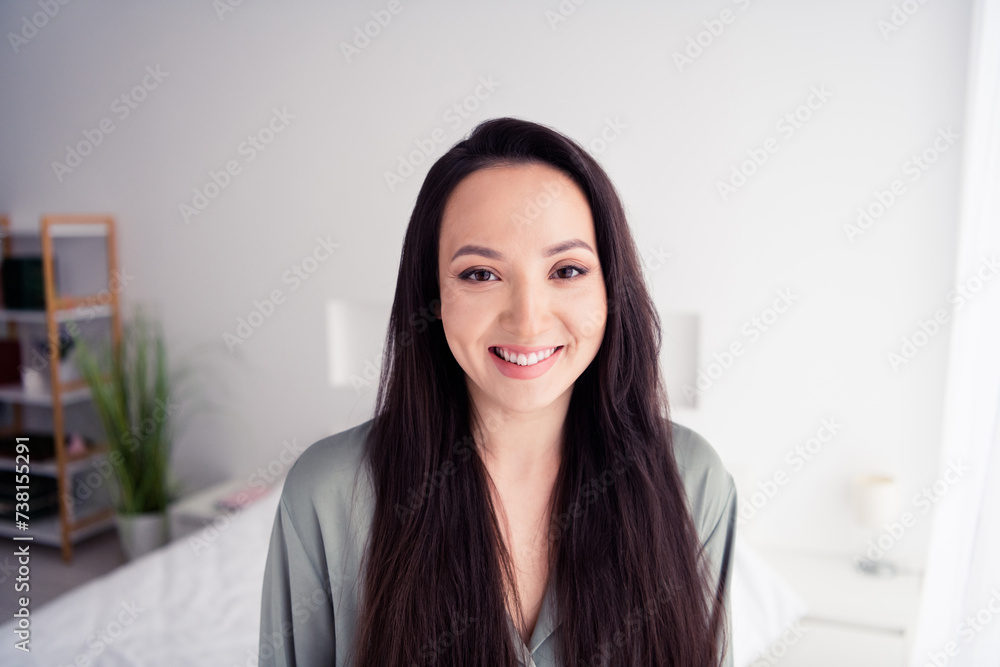 Photo portrait of pretty young girl toothy smile wear trendy gray nightwear isolated on comfortable modern white bedroom interior Photo portrait of pretty young girl toothy smile wear trendy gray nightwear isolated on comfortable modern white bedroom interior