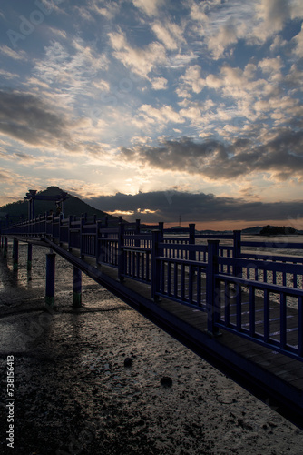 View of the bridge at the seaside during sunset