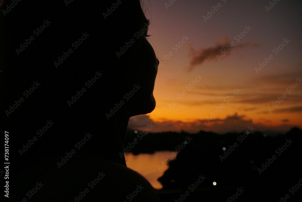 Silhouette of a girl at sunset
