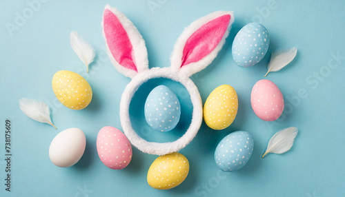 Easter party concept. Top view photo of easter bunny ears white pink blue and yellow eggs on isolated pastel blue background