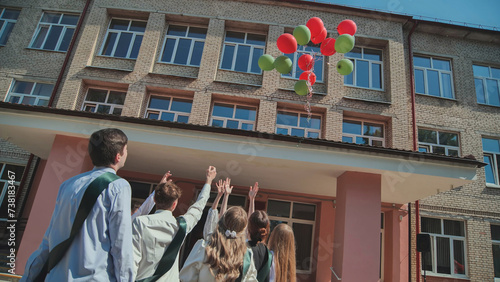 High school graduates launch balloons into the sky.