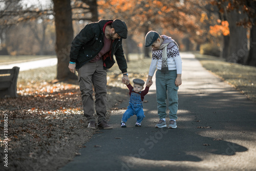 Fathers Day. Brothers and their dad enjoying time together in nature.Candid real family moment.