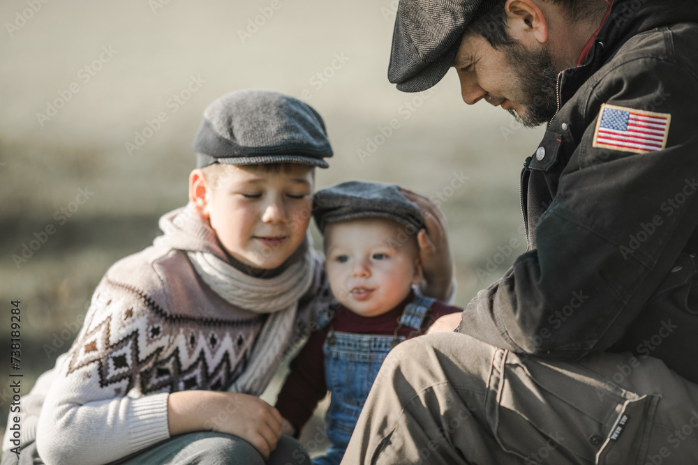 Fathers Day. Brothers and their dad enjoying time together in nature.Candid real family moment. Fathers Day. Brothers and their dad enjoying time together in nature.Candid real family moment.