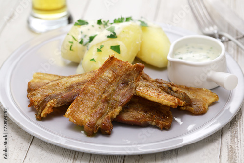 "Stegt flæsk med persillesovs" (sliced pork belly with skin on and fried, served with parsley sauce and boiled potatoes). Denmark's national food.
