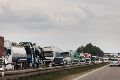 Queue of Trucks on Ukraine-Poland Border traffic jam at Sunset During Protest Roadblock. Business agricultural Logistics blockade action. Cargo lorry semi-trailers stuck