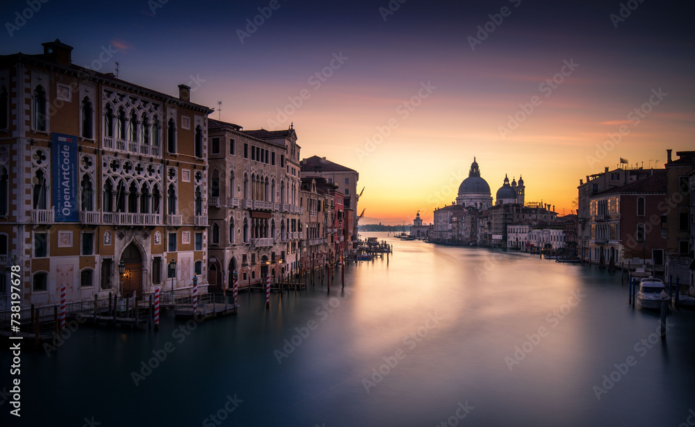 A River Running Through a City Next to Tall Buildings in Venice