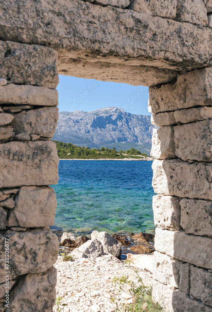 Doorway of an old stone house on idyllic beach on Vrnik island near Korcula, Croatia