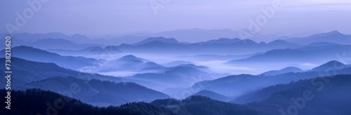 Hills and mountains in fog. Horizontal landscape photography. Panoramic aerial view. Image for banner, blog, advertisement.