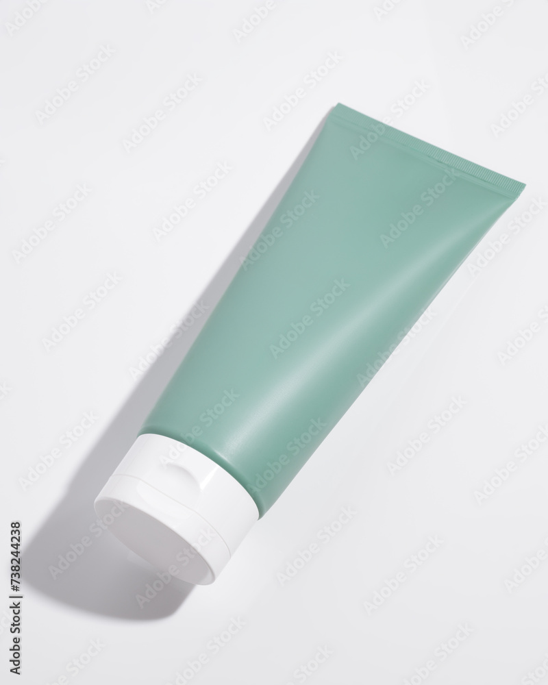 Blank plastic cosmetic tube on white background. Cosmetic beauty product branding mockup. Copy space Blank plastic cosmetic tube on white background. Cosmetic beauty product branding mockup. Copy space