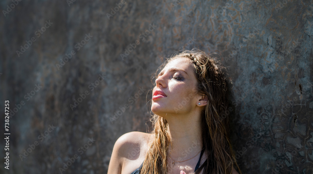 Naklejka premium Beauty face of younf woman with natural healthy skin. Beautiful female portrait. Young woman with clean fresh skin, outdoor summer. Face care, facial treatment, cosmetology, beauty and spa.