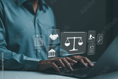 Businessman or Lawyer working with legal services icons on a laptop virtual screen can legal advice online such as labor law for business or company. Notary public, business legislation, justice, photo