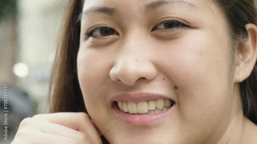 young Asian woman teasing someone by making the tongue