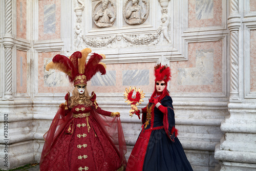 Venice, Italy - February 2024 - carnival masks are photographed with tourists in San Marco square