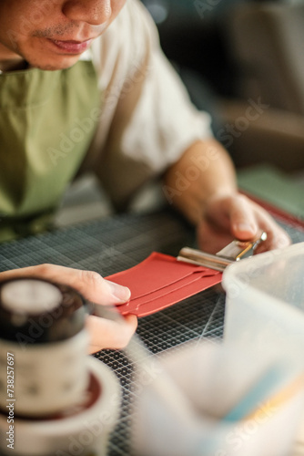 Leather craftsman working with leather glue