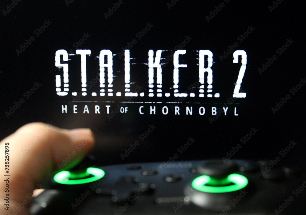 Gamer playing Stalker 2 on a gamepad. Stock editorial photo with