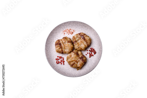 Round minced chicken or pork cutlet wrapped in bacon with salt, spices and herbs