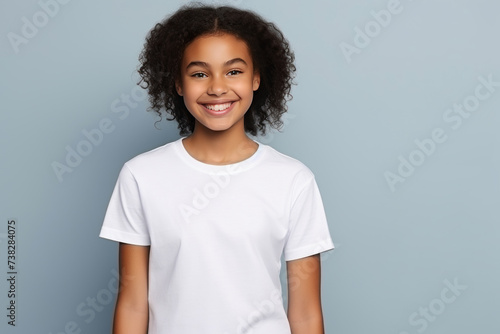 Smiling Girl wearing white T-Shirt Mockup on white studio background. Generative Ai © Anthony Paz