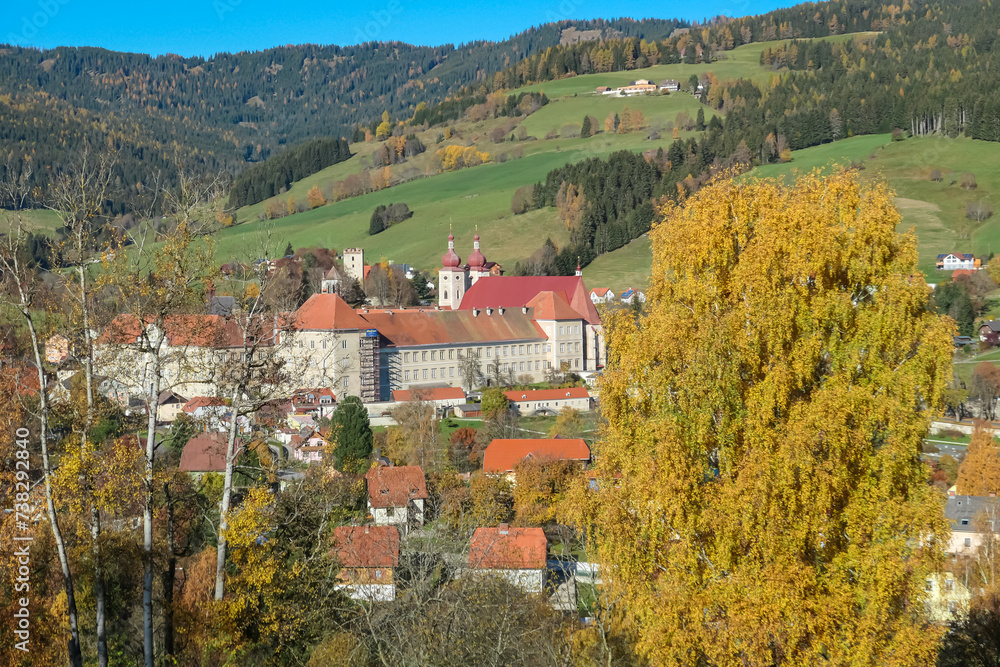 Benedictine monastery Saint Lambrecht Abbey surrounded by lush green alpine landscape in mountain village Grebenzen, Gurktal Alps, Styria, Austria. Calm serene atmosphere in Austrian Alps in autumn
