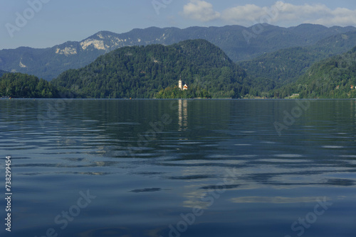 view of gorgeous clear water blue lake and mountains around in slovenia  photo