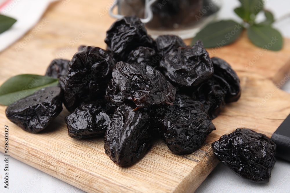 Tasty dried prunes on table, closeup view Tasty dried prunes on table, closeup view