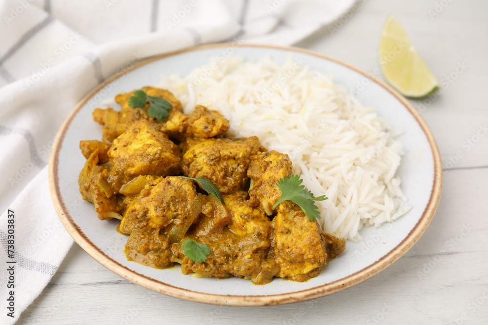 Delicious chicken curry with rice on white wooden table Delicious chicken curry with rice on white wooden table