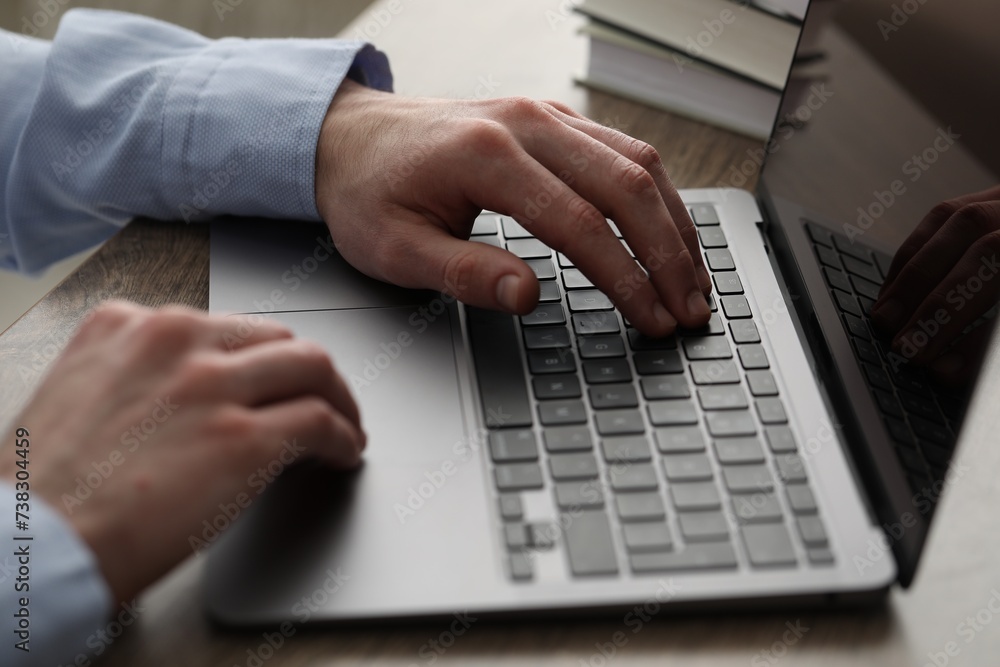 E-learning. Man using laptop during online lesson at table indoors, closeup E-learning. Man using laptop during online lesson at table indoors, closeup