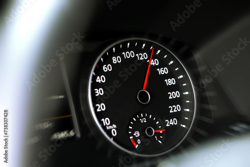 Speedometer on car dashboard, closeup. Motion blur effect