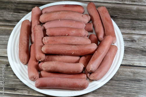 Foto boiled hot dog,  dish consisting of a grilled, steamed, or boiled sausage served
