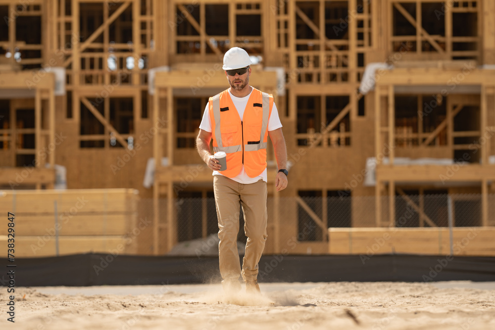 Caucasian man construction worker in helmet at building. Construction building. Construction site manager. Worker in helmet on the new building. Builder with hardhat helmet on construction site. Caucasian man construction worker in helmet at building. Construction building. Construction site manager. Worker in helmet on the new building. Builder with hardhat helmet on construction site.