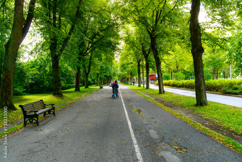 Photography Pedestrians on a shady path along Stadsparken public park on Djurgarden Museum Island, in Stockholm, Sweden