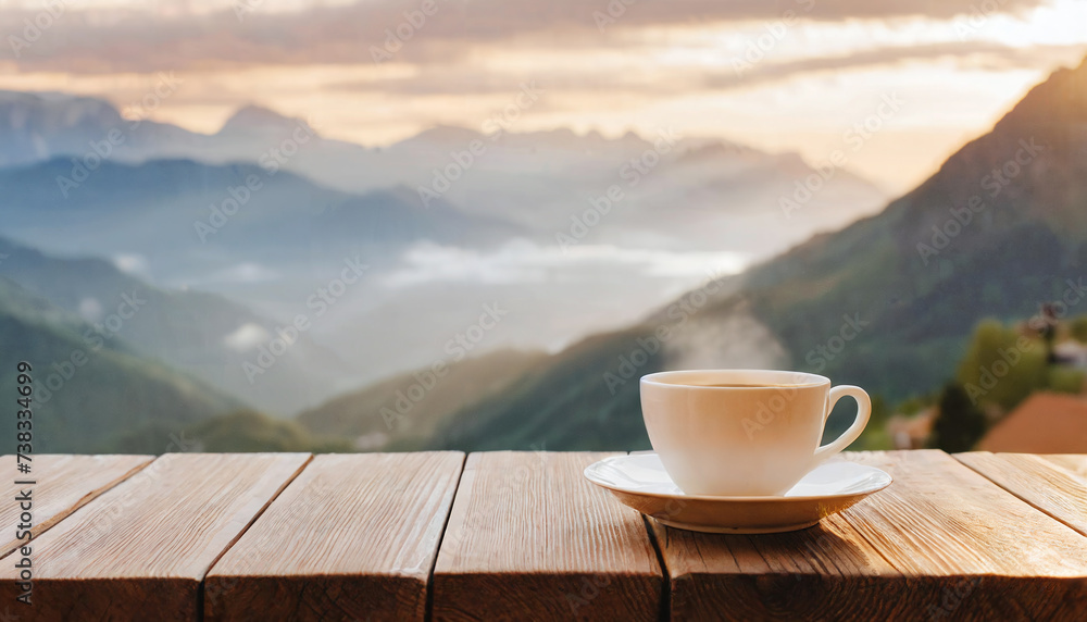 Hot cup of coffee on wooden table with mountain landscape in background Hot cup of coffee on wooden table with mountain landscape in background