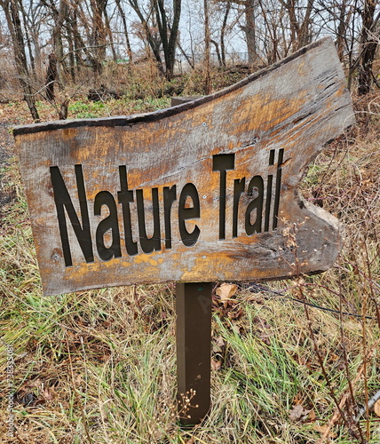 Wooden nature trail sign. Outdoors. Daytime. Late Autumn/Early Winter. 