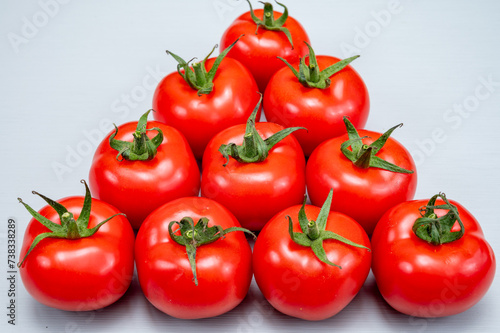 Food triangle, Red ripe tasty Dutch tomatoes, vegetables background top view close up copy space © barmalini