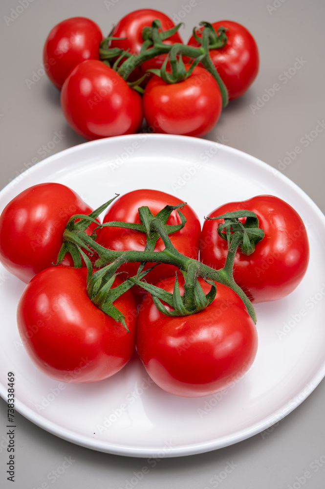 Red ripe tasty Dutch tomatoes growing indoor in greenhouse all seasons, food industry in Netherlands close up Red ripe tasty Dutch tomatoes growing indoor in greenhouse all seasons, food industry in Netherlands close up