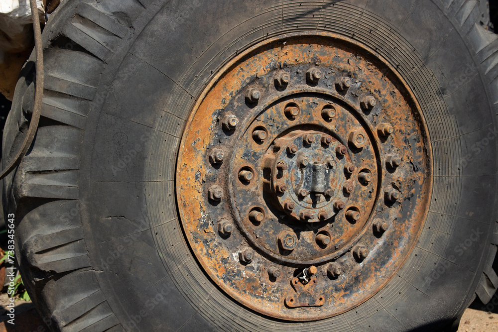 a big truck wheel with lots of fasteners a big truck wheel with lots of fasteners