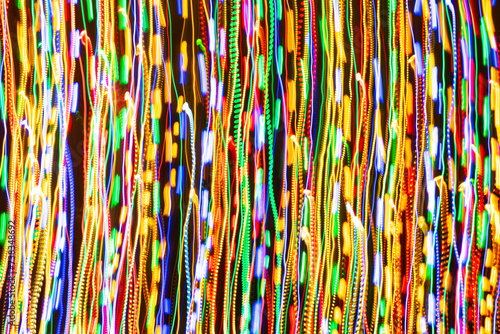 Psychedelic abstract long exposure motion colour lights. Light trails, leaks and glowing electricity. Music visualisation abstraction background. Christmas holiday festive lights. photo