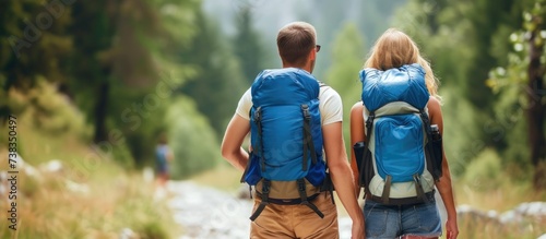 Hiking couple with backpack exploring the woods.