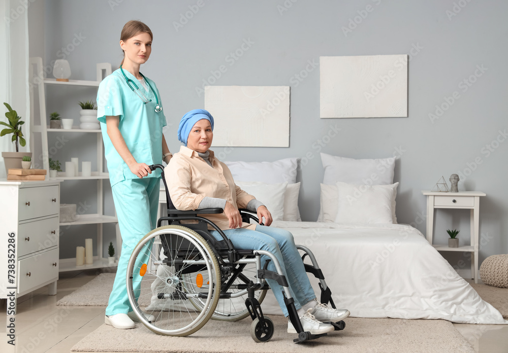 Mature woman after chemotherapy in wheelchair with nurse at home. Stomach cancer concept Mature woman after chemotherapy in wheelchair with nurse at home. Stomach cancer concept