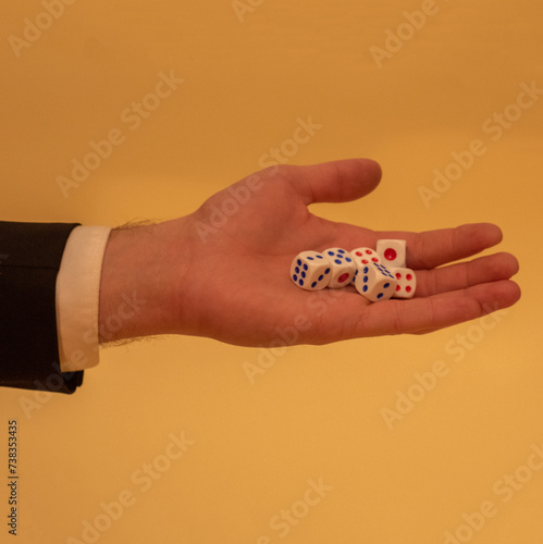 Man in suit holding gambling dice. Business and social issues concept. 