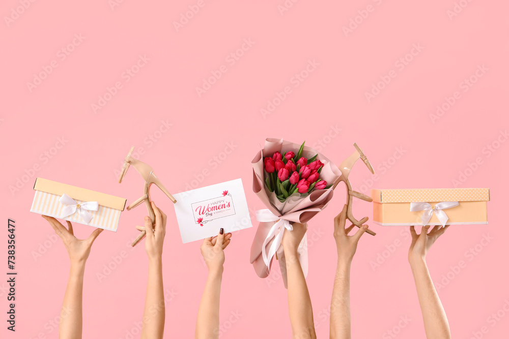 Female hands with bouquet of tulips, high heel shoes and gift boxes on pink background. Shopping for International Women's Day - obrazy, fototapety, plakaty 