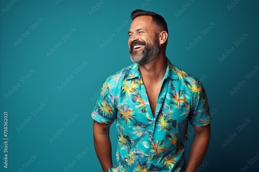 Portrait of a happy mature man in a colorful shirt over blue background Portrait of a happy mature man in a colorful shirt over blue background