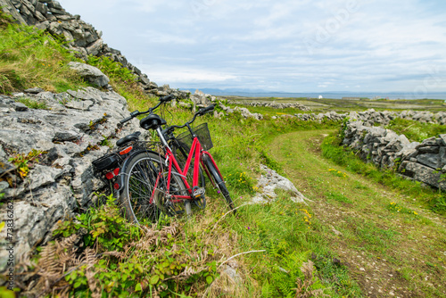 Bikes parked on Inishmore, the largest of the Aran Islands in Galway Bay. Renting a bicycle is one of the most popular way to get around Inis Mor, Ireland. photo